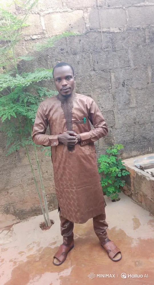 Man in Brown Tunic Smiles Gently in Courtyard – AI Generated Video | Hailuo AI