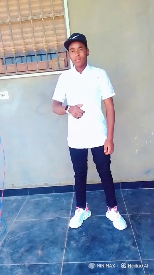 Young Man in White Shirt on Patio Examines Watch – AI Generated Video | Hailuo AI