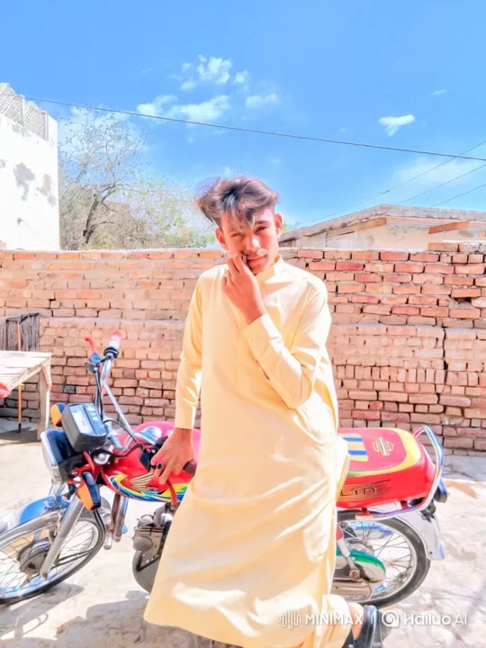 Young Man in Yellow Tunic Poses with Motorcycle – AI Generated Video | Hailuo AI