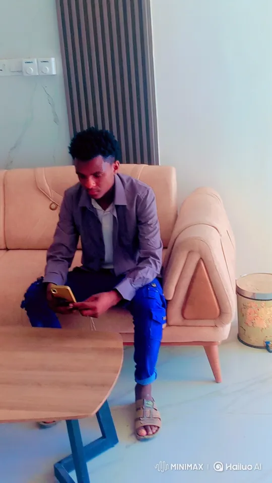 Young Man Engages with Phone, Meets Camera's Gaze – AI Generated Video | Hailuo AI