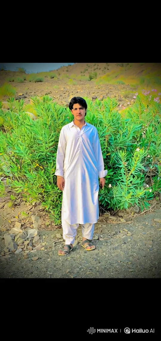 Young Man in White in Gentle Breeze Amidst Hilly Landscape – AI Generated Video | Hailuo AI