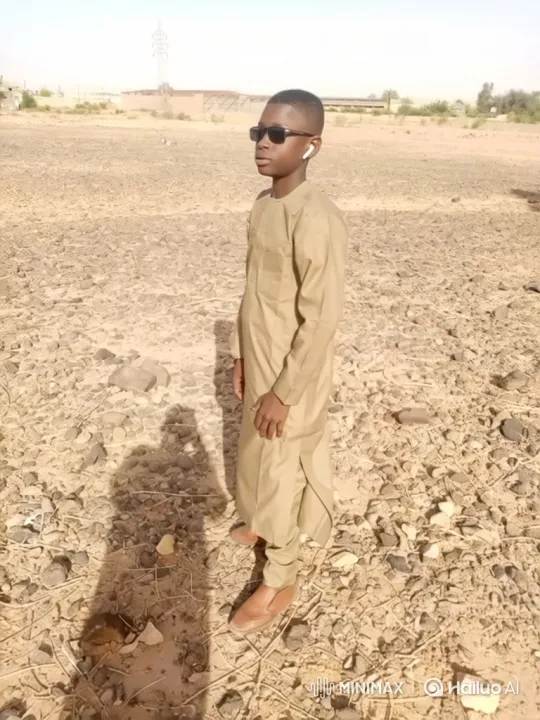 Young Boy in Arid Landscape: A Slow Zoom and Turn – AI Generated Video | Hailuo AI