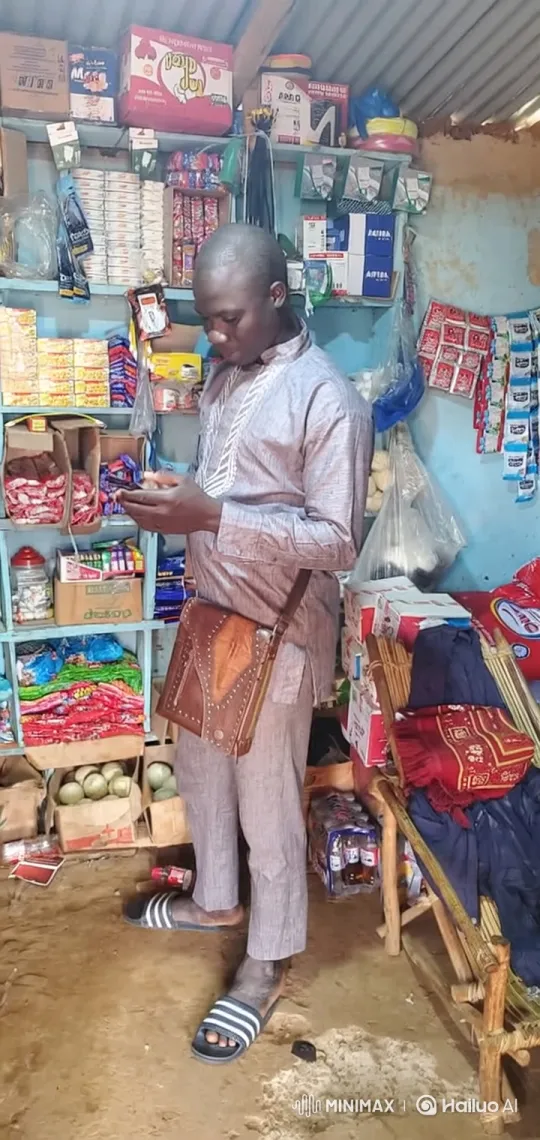 Man in Shop Focused on Smartphone – AI Generated Video | Hailuo AI