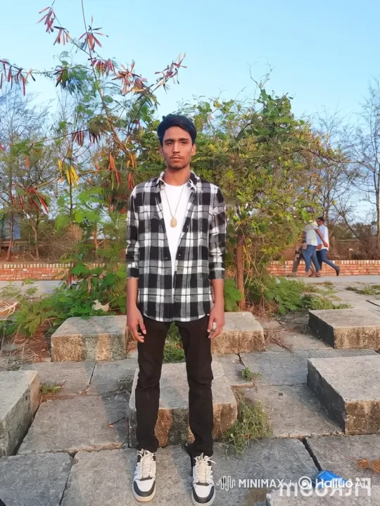 Young Man Smiles in Park Setting – AI Generated Video | Hailuo AI