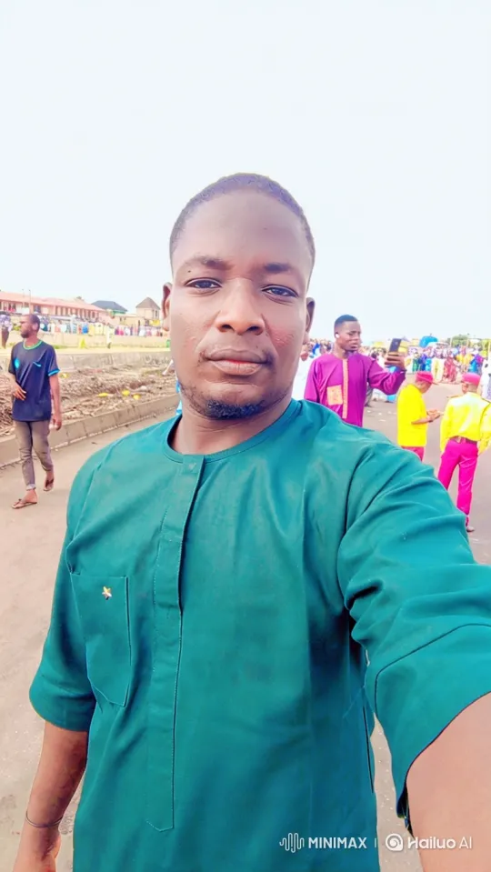 Man in Teal Tunic Walks Along Road, Camera Follows – AI Generated Video | Hailuo AI