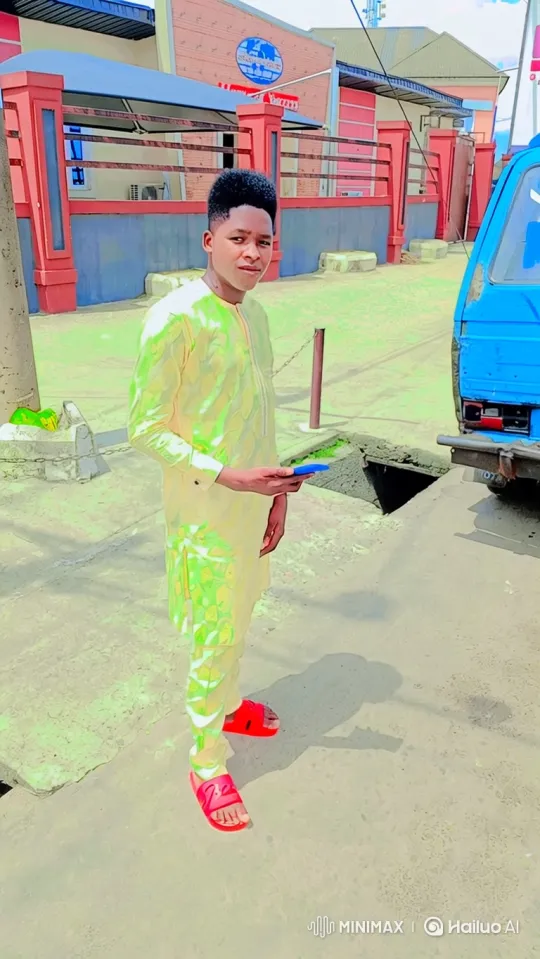 Young Man Stands Still as Truck Moves, Revealing Building – AI Generated Video | Hailuo AI
