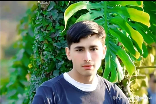 Young Man in Nature, Steady Gaze Amidst Gentle Breeze – AI Generated Video | Hailuo AI
