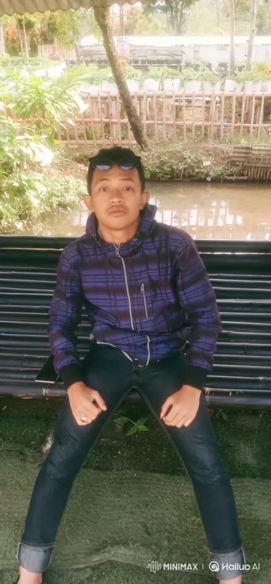 Young Man on Bamboo Bench in Tranquil Setting – AI Generated Video | Hailuo AI
