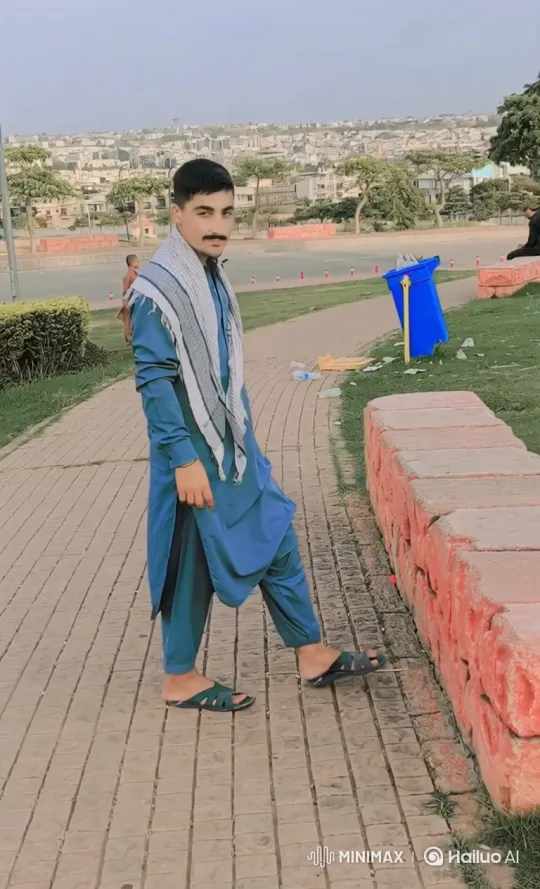 Young Man in Park Amidst Cityscape – AI Generated Video | Hailuo AI