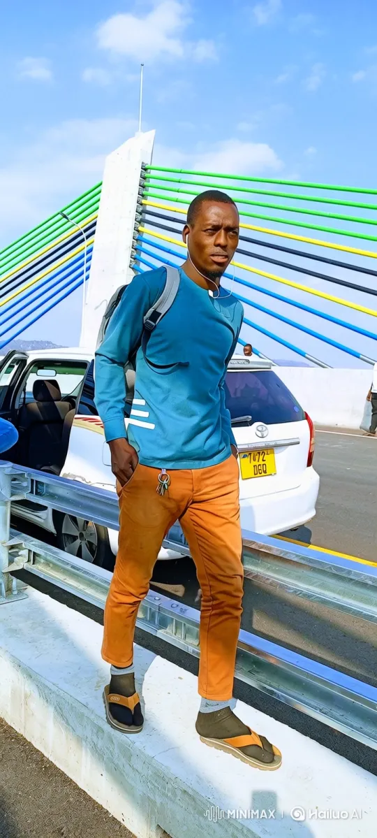 Man in Blue Shirt Stands on Bridge's Edge – AI Generated Video | Hailuo AI