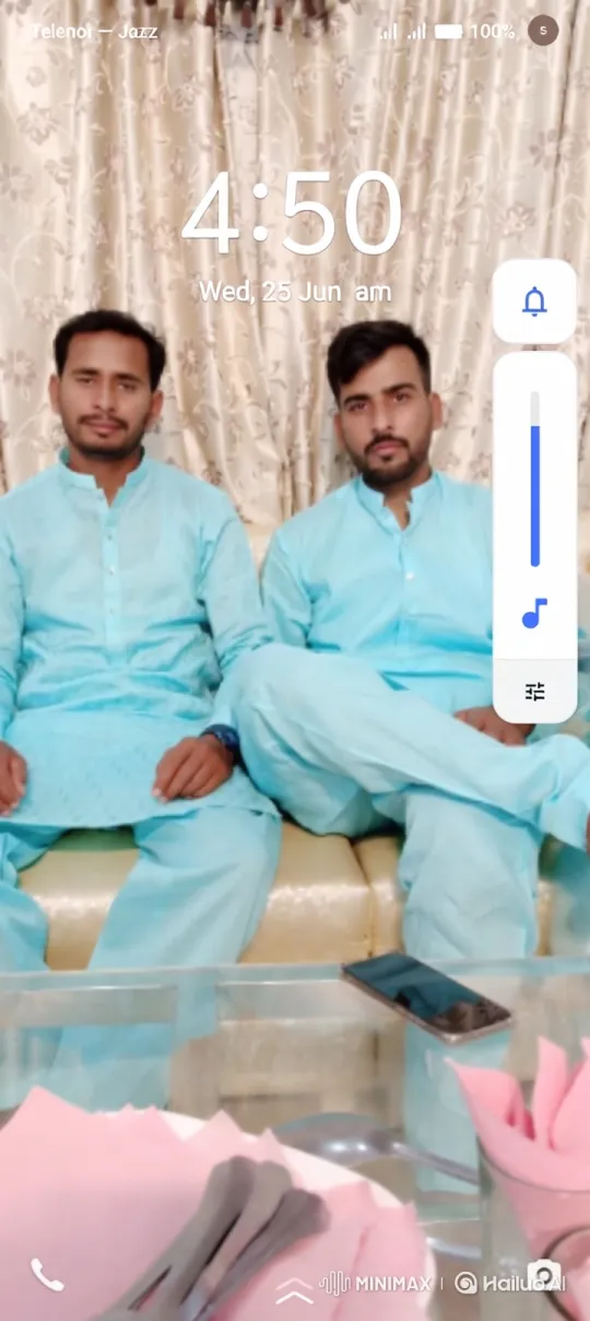 Two Men in Traditional Dress on a Couch with Camera Movement – AI Generated Video | Hailuo AI