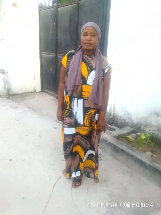 Woman in Colorful Dress, White Wall, and Black Gate – AI Generated Video | Hailuo AI