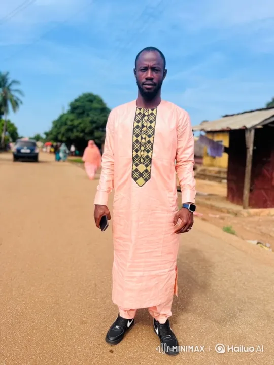 Man in Traditional Attire Stands Calmly on Dirt Road – AI Generated Video | Hailuo AI