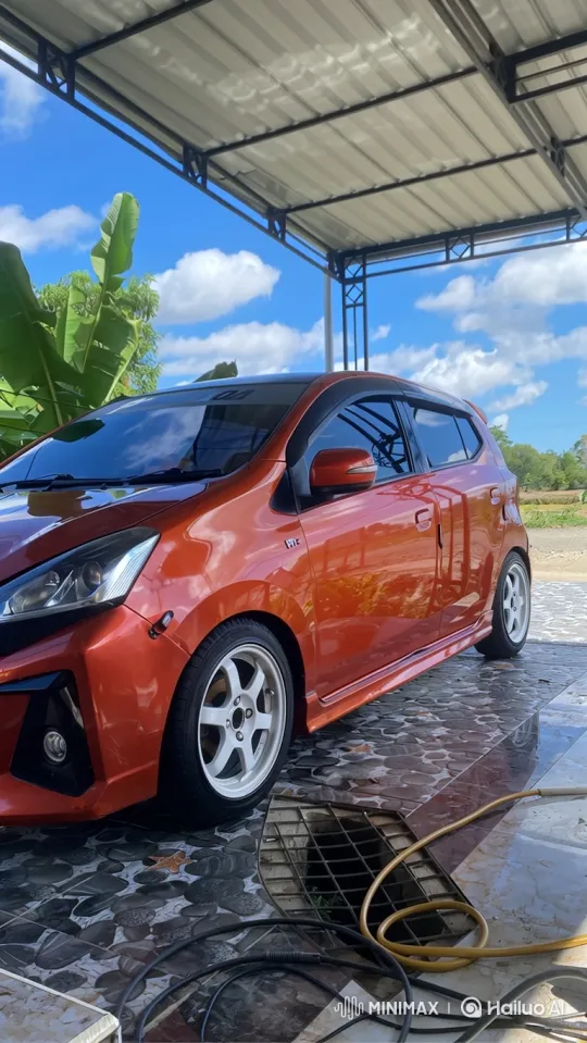Static Shot of Orange Hatchback Transforming with Adjustable Suspension – AI Generated Video | Hailuo AI