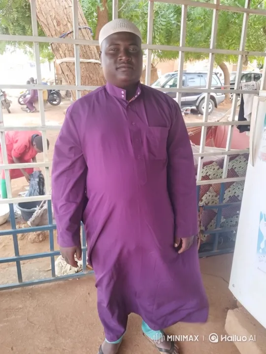 Man in Purple Smiles Gently in Outdoor Setting – AI Generated Video | Hailuo AI