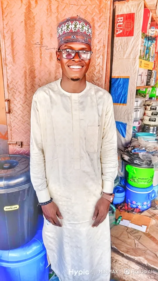 Young Man Greets with a Smile in Market Stall – AI Generated Video | Hailuo AI