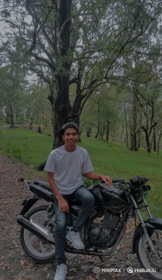 Young Man Smiling on Motorcycle in Forest Setting – AI Generated Video | Hailuo AI