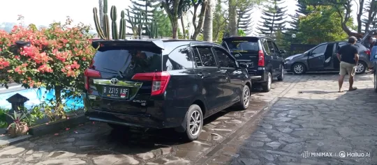 Black Car Lowers on Wet Driveway Amid Resort-Like Scenery – AI Generated Video | Hailuo AI