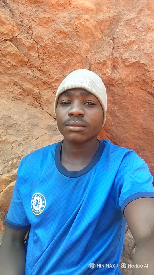 Young Man in Blue Jersey Smiles Gently in Close-Up – AI Generated Video | Hailuo AI