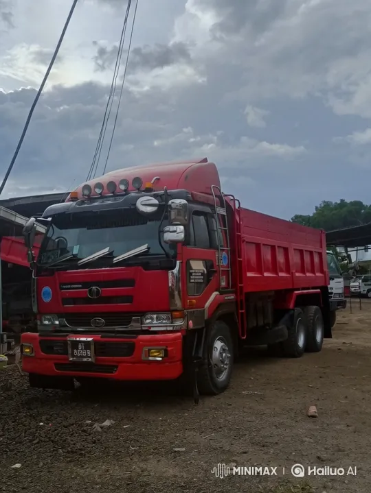 Red Dump Truck Lowers on Gravel Lot Under Stormy Sky – AI Generated Video | Hailuo AI