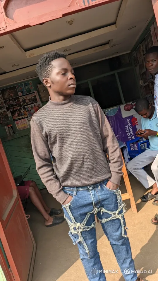Young Black Man Observes Daily Life in Open-Front Shop – AI Generated Video | Hailuo AI