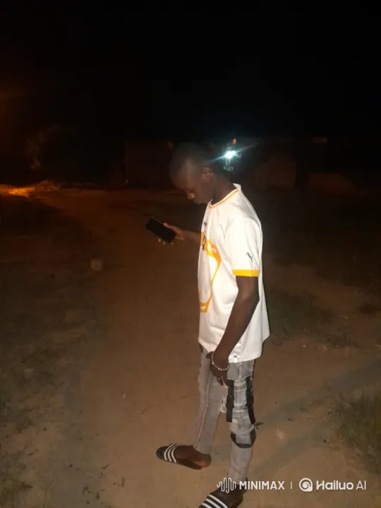 Young Man Immersed in Smartphone at Night – AI Generated Video | Hailuo AI