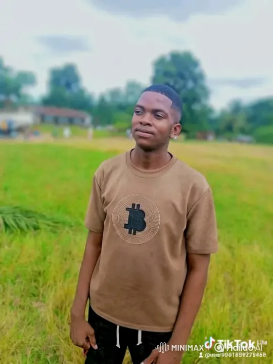 Young Man in Field with Bitcoin Shirt Smiles Gently – AI Generated Video | Hailuo AI