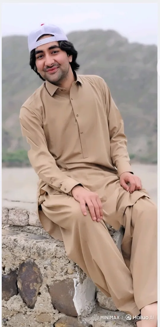 Young Man on Stone Wall with Gentle Smile – AI Generated Video | Hailuo AI