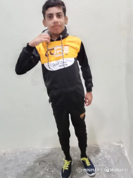 Young Boy in Tracksuit Smiles Gently at Camera – AI Generated Video | Hailuo AI