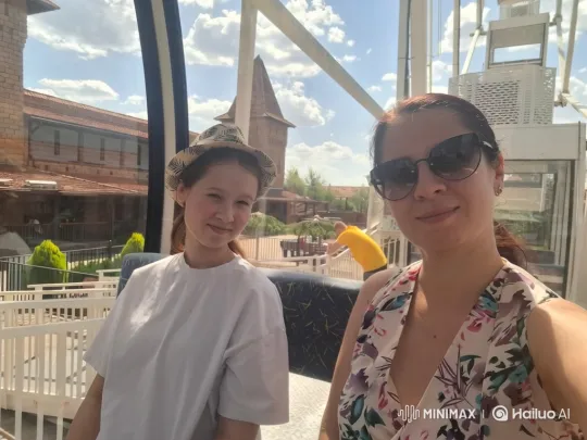 Woman and Girl Enjoy Theme Park View from Ferris Wheel – AI Generated Video | Hailuo AI