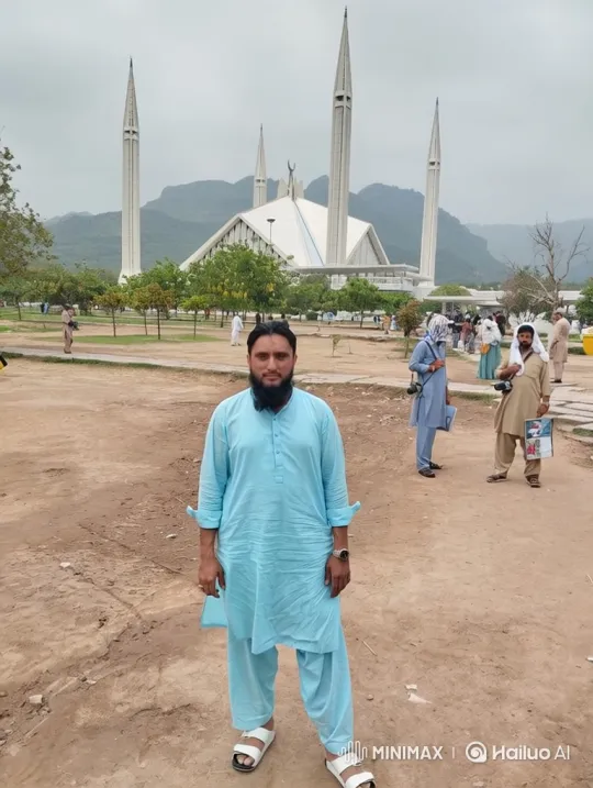 Man in Blue Attire Stands Calmly Before White Mosque – AI Generated Video | Hailuo AI