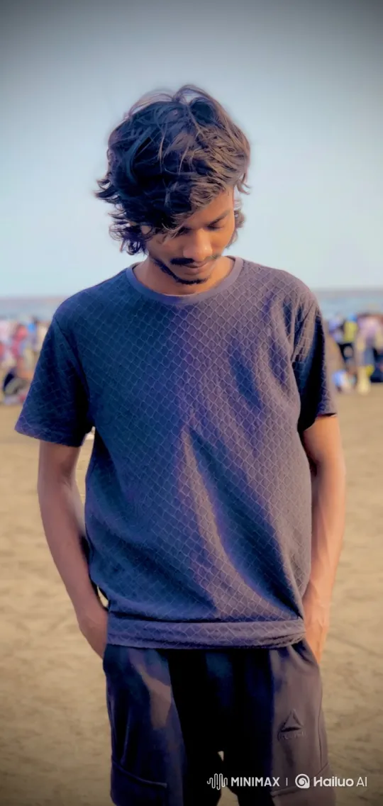 Contemplative Young Man on Sandy Beach – AI Generated Video | Hailuo AI
