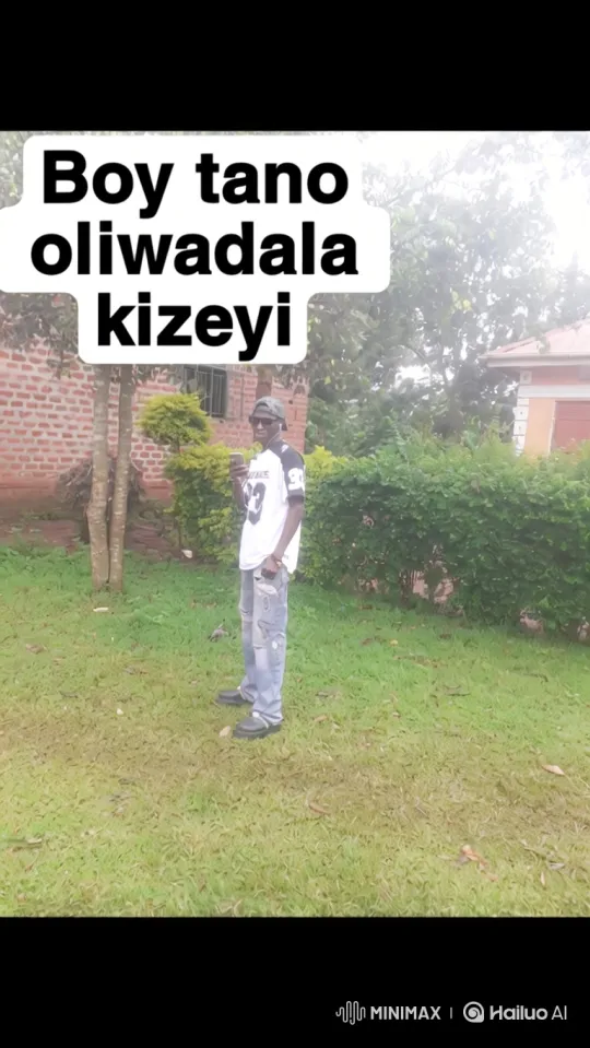 Young Man in Jersey Stands on Lawn, Uses Phone – AI Generated Video | Hailuo AI