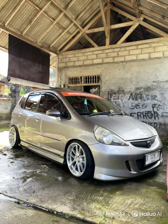Silver Hatchback Demonstrates Smooth Air Suspension Lowering – AI Generated Video | Hailuo AI