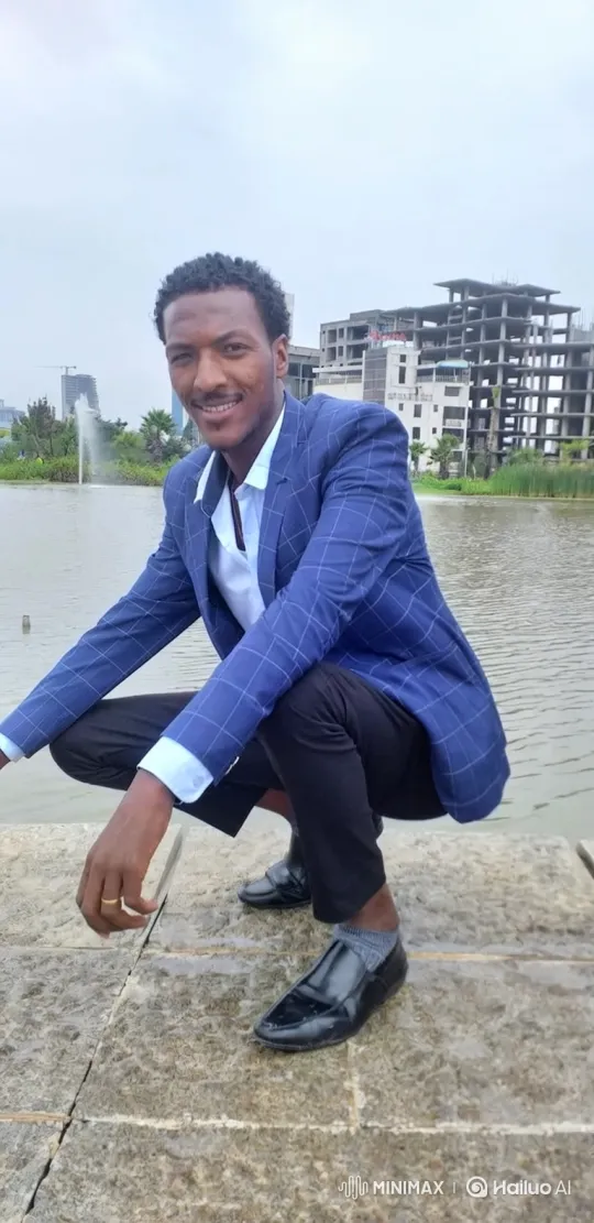 Young Man in Plaid Blazer by City Pond – AI Generated Video | Hailuo AI