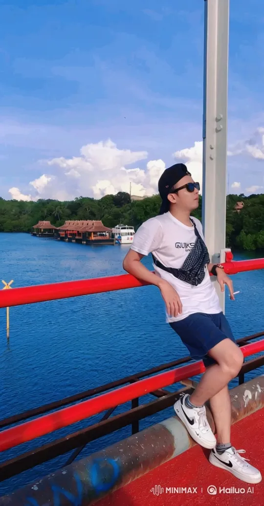 Scenic Bridge Pan with Man and Expansive Waterfront – AI Generated Video | Hailuo AI