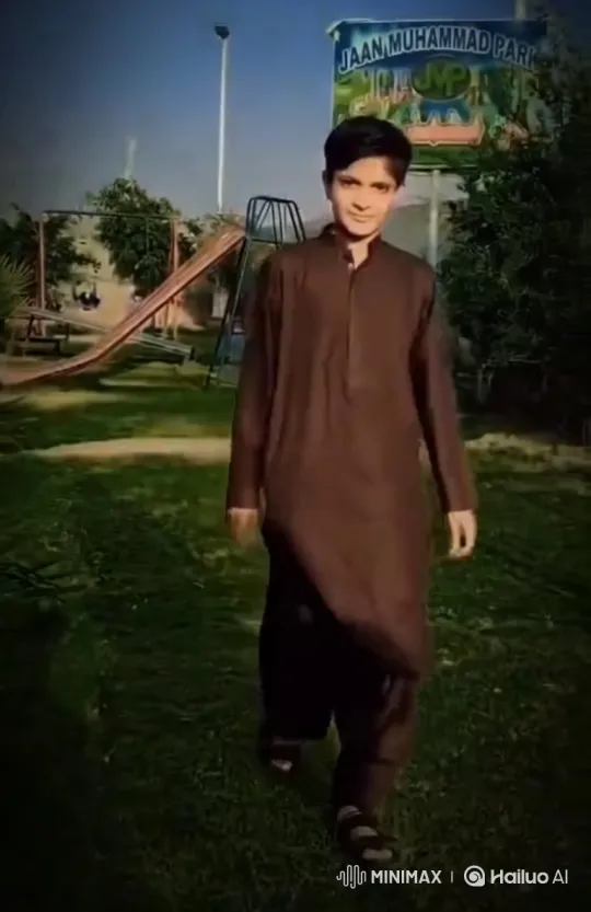 Young Man Walking Steadily Across Park Lawn – AI Generated Video | Hailuo AI