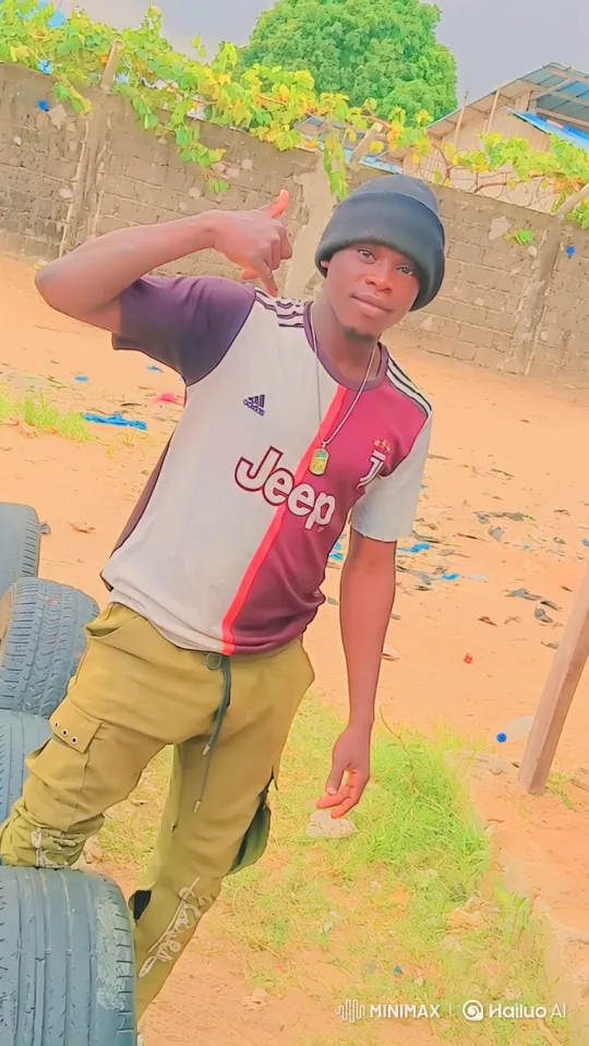 Young Man in Soccer Jersey Signals and Smiles in Outdoor Yard – AI Generated Video | Hailuo AI