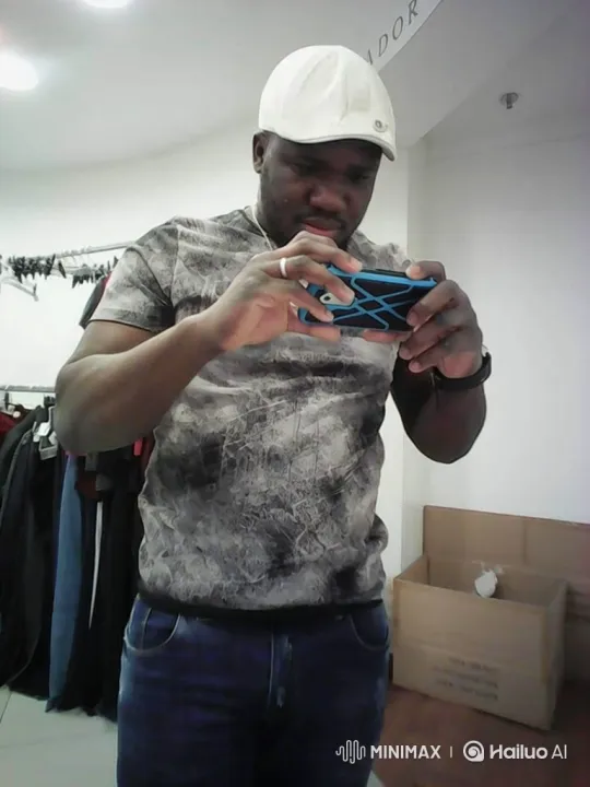 Man Engaged with Smartphone in Clothing Store Stockroom – AI Generated Video | Hailuo AI