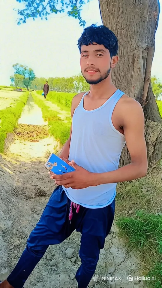 Young Man Stands by Tree in Rural Landscape – AI Generated Video | Hailuo AI