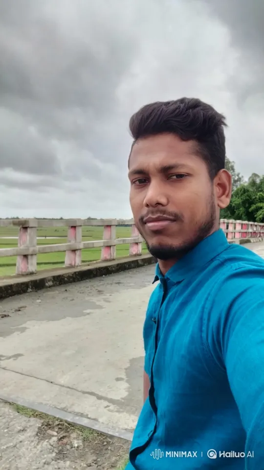 Young Man Smiles on Bridge Amidst Gentle Breeze – AI Generated Video | Hailuo AI