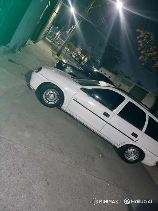 White Station Wagon Lowers on Paved Street at Night – AI Generated Video | Hailuo AI