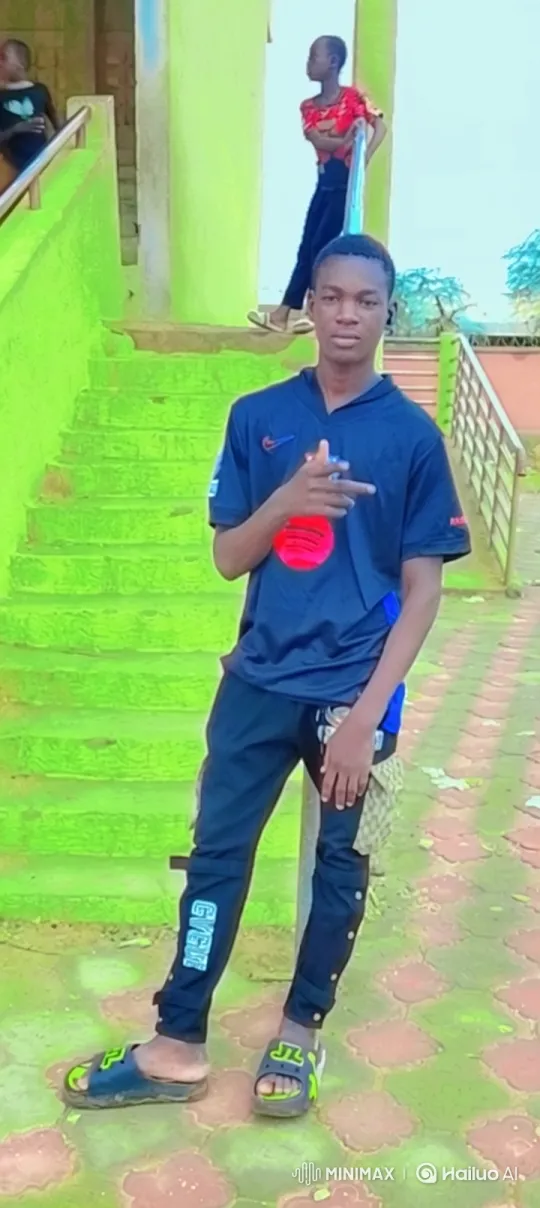 Young Man in Casual Pose with Background Activity – AI Generated Video | Hailuo AI