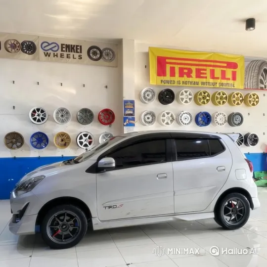 Silver Hatchback with Air Suspension Lowers in Wheel Shop – AI Generated Video | Hailuo AI