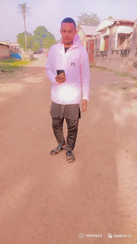 Young Man in Hooded Jacket Stands Still, Observes Swaying Trees – AI Generated Video | Hailuo AI