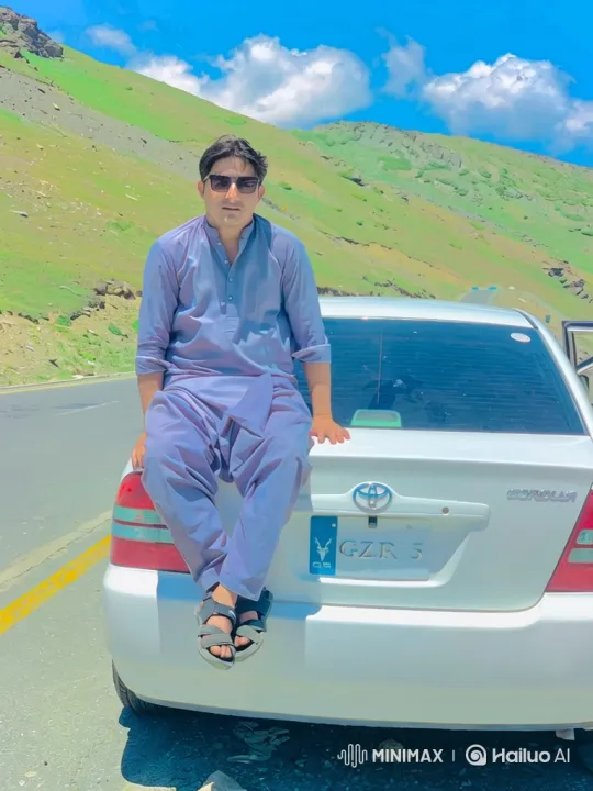 Man on Car Trunk Amidst Mountainous Landscape – AI Generated Video | Hailuo AI