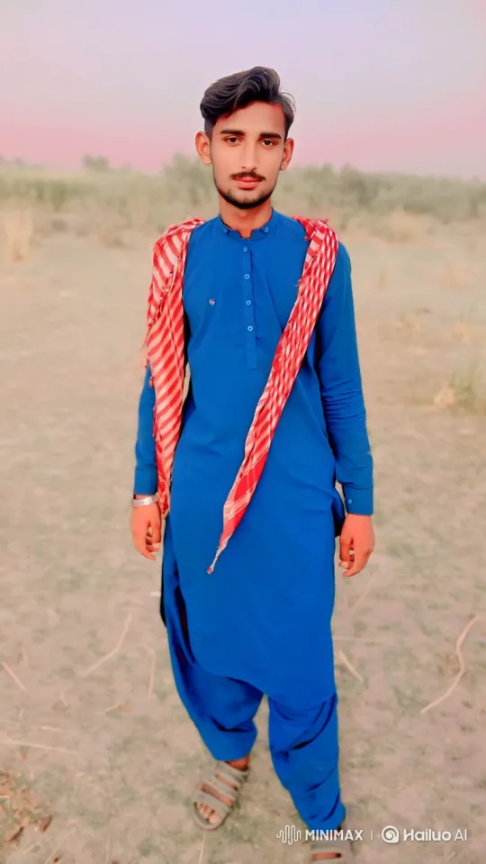Young Man in Royal Blue Attire Amidst Serene Landscape – AI Generated Video | Hailuo AI