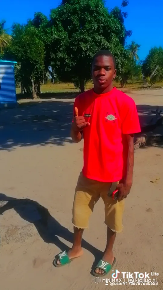 Young Man in Red T-Shirt Walks Across Sandy Ground – AI Generated Video | Hailuo AI
