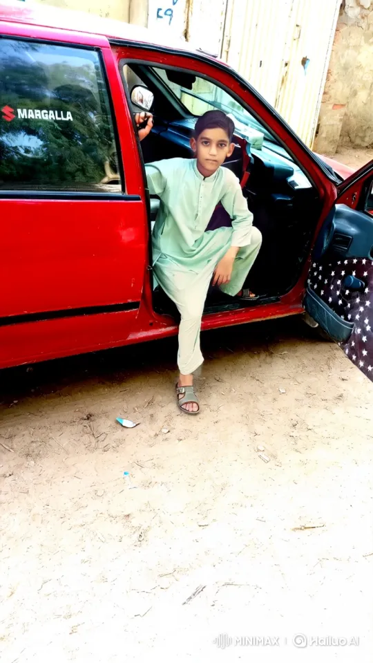 Young Boy Steps Out of Red Car, Approaches Camera – AI Generated Video | Hailuo AI