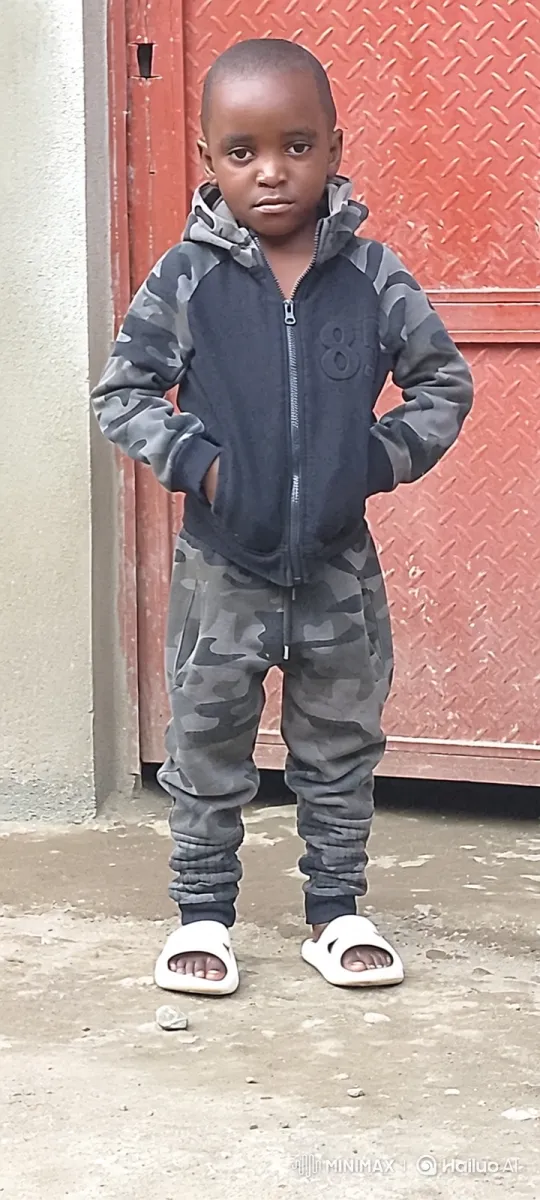 Young Black Boy in Camouflage Clothing Stands Confidently – AI Generated Video | Hailuo AI